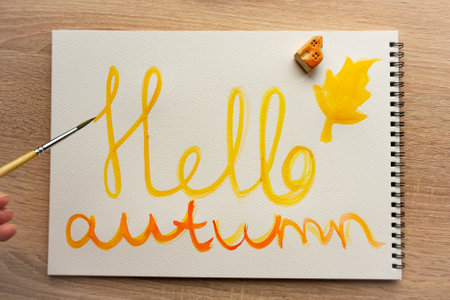 Autumn inscription painted in Watercolor, Yellow and orange color, Brush on the albumの写真素材