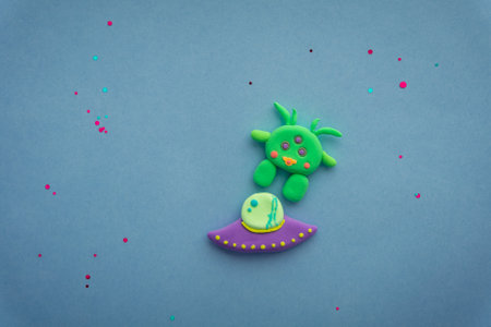 Plasticine 3D UFO, spaceship sculpture, cute green alien on starry backgroundの写真素材