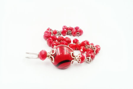 Patterned beaded bracelet, red color, associated with silver color metalの写真素材