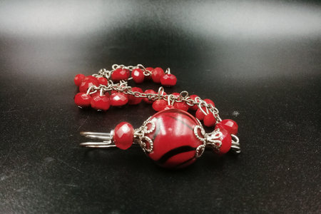 Patterned beaded bracelet, red color, associated with silver color metalの写真素材