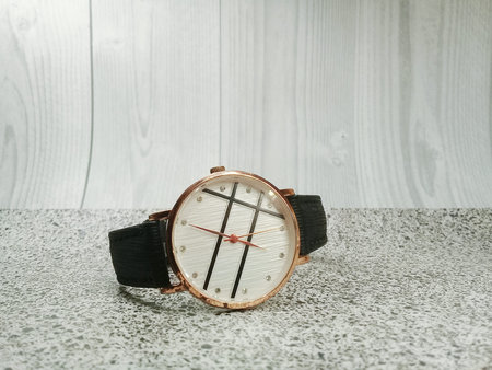 White analog watch with black faux leather bracelet