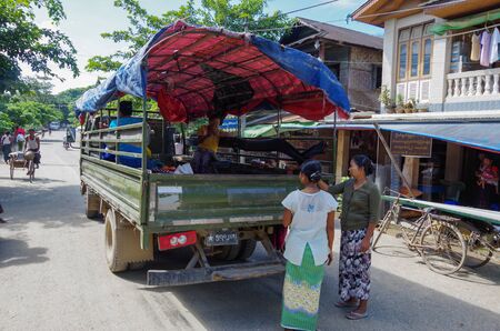 Mrauk-u, Rakhine State / Myanmar - October 18 2016: Women waiting at a pickup truck on the main roadのeditorial素材