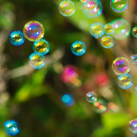 Soap bubbles on green grass background. Shallow depth of field.