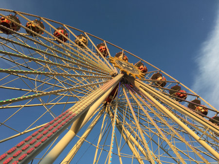 BERLIN - JUNE 3, 2017: Ferris Wheel (Riesenrad) at German Fun Fair in warm afternoon light - low angle sunnyのeditorial素材