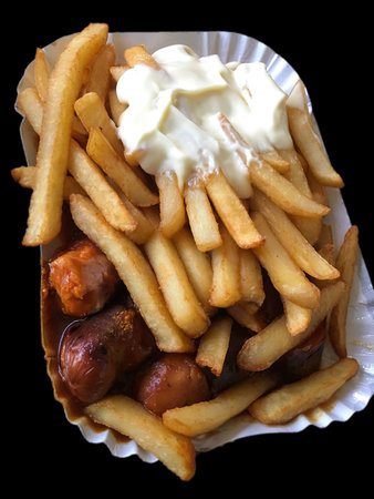 Currywurst & Pommes on black background: Famous German Fast Food (Curry Sausage with French Fries...