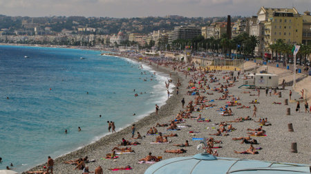 Nice, France -September 02, 2011: People sun bathing and swimming on the beach of Nice in France, Cote d'Azur and mediterranean sea in summerのeditorial素材