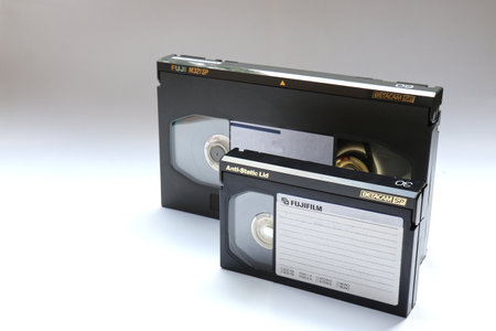 BERLIN, GERMANY - SEPTEMBER 4, 2019: A large and a small Betacam SP Tape which were used for professional Video Recording in Standard Definition in Broadcast. The big one captures up to 60 minutes, the small one 30 minutes. Also just called Beta SP.のeditorial素材