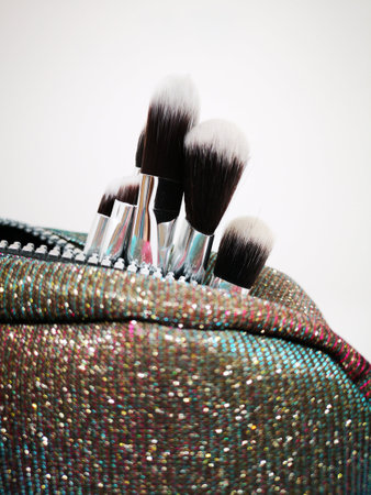 paint brushes burst from a glittery handbagの写真素材