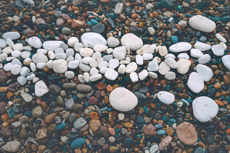 a collection of smooth, rounded stones of varying sizes and colorsの写真素材