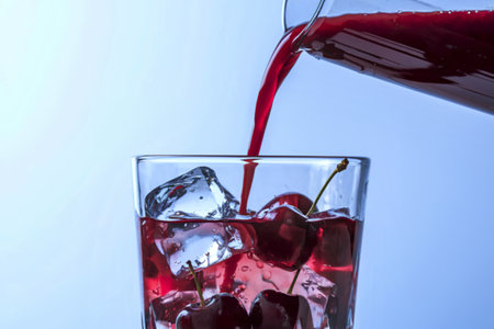 a glass filled with vibrant, deep red cherry juiceの写真素材