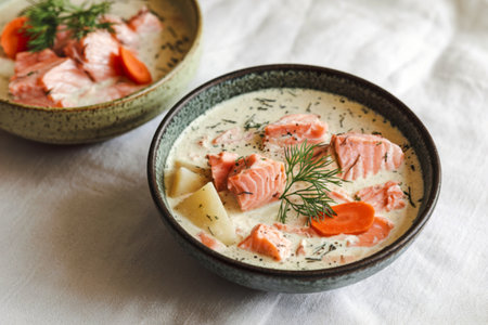 two bowls of creamy salmon soupの写真素材