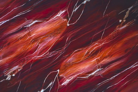 polished marble background with a deep red hue.の写真素材