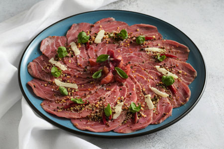 veal carpaccio with Parmesan cheese, spices, and herbsの写真素材