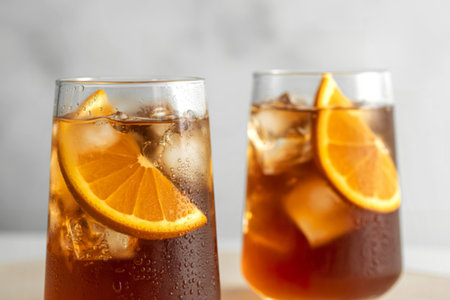 slender glass tumblers filled with refreshing iced teaの写真素材