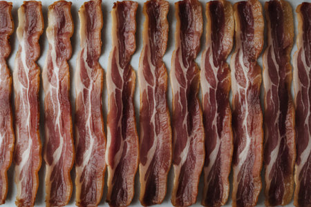 A photo of raw bacon strips of pork meat.の写真素材