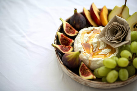 A photo of homemade ricotta cheese served with fresh fruit