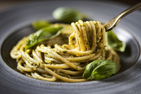 A photo of a close-up shot of spaghetti pasta with pesto sauceの写真素材