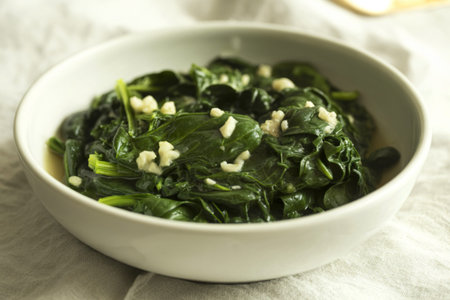 A photograph of a bowl filled with freshly steamed spinach