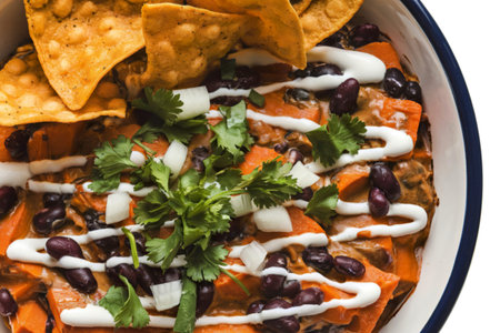 A photo of a Mexican-style dip served in a white ceramic bowl
