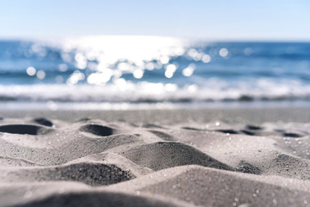A photo of a pristine beach with soft, undulating  sand in the foreground