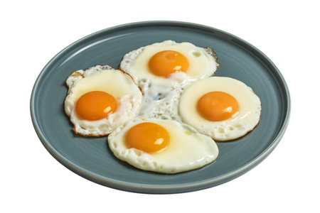 A photograph of four perfectly sunny-side-up eggs