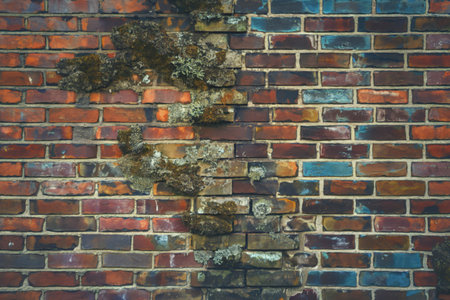 a weathered brick wall with a blend of warm and cool tonesの写真素材