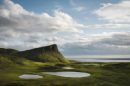 a serene landscape dominated by rolling green hillsの写真素材