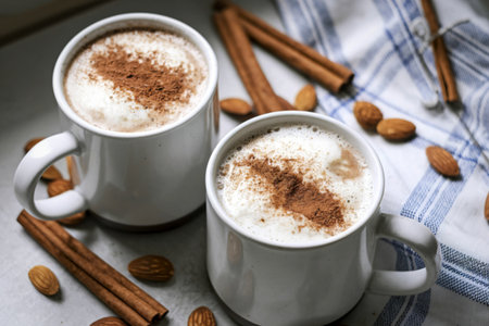 two white mugs placed side by side on a wooden surfaceの写真素材