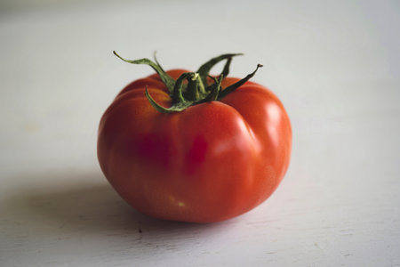 a single, perfectly ripe tomatoの写真素材