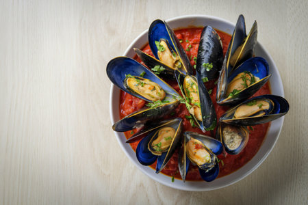 A photo of a seafood dish of mussels cooked in tomato sauceの写真素材