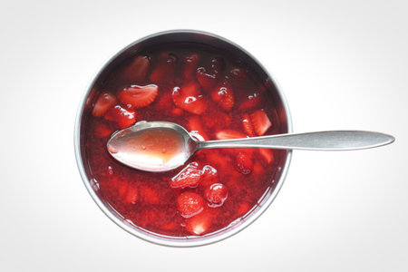 a bowl filled with vibrant, glistening strawberry jamの写真素材