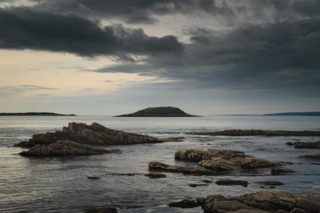 rugged rocks protruding from calm watersの写真素材