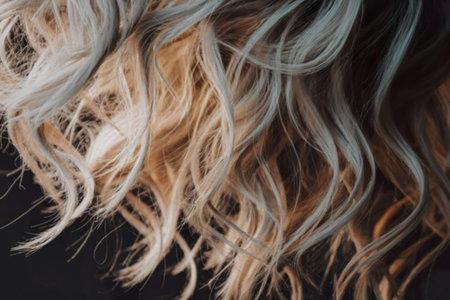 A close-up photograph of luxurious wavy blonde hairの写真素材