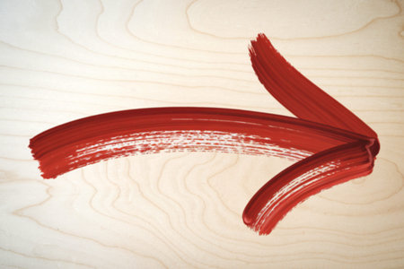 a brush stroke against a light wooden background