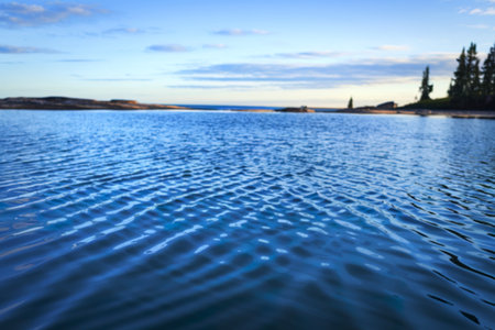 A photo of a vast expanse of deep blue waterの写真素材