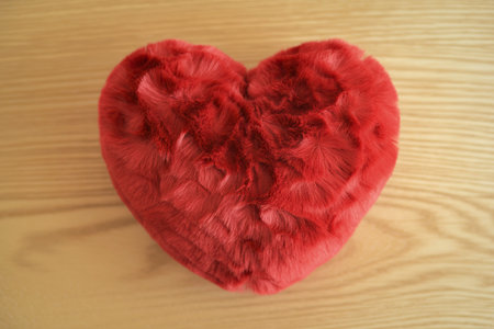 a plush, fluffy red heart-shaped pillow or stuffed objectの写真素材
