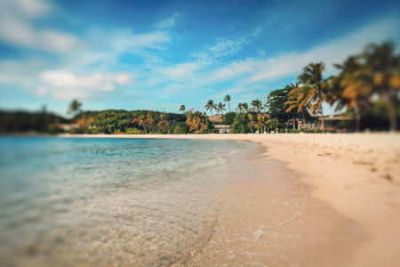 a bokeh clear blue ocean and a sandy beachの写真素材