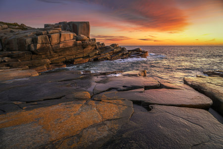 a dramatic rocky coastline at sunsetの写真素材