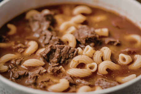 A close-up photo of a bowl filled with a pasta soup