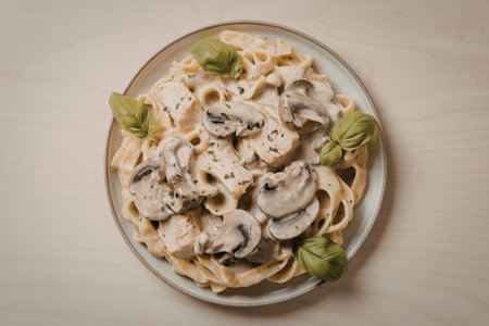 a creamy pasta dish with chunks of chickenの写真素材