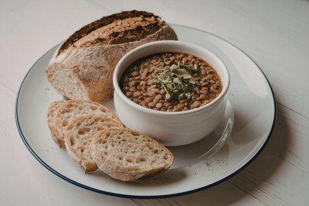 a white plate with a bowl of lentil soupの写真素材