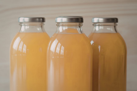 glass bottles filled with juiceの写真素材