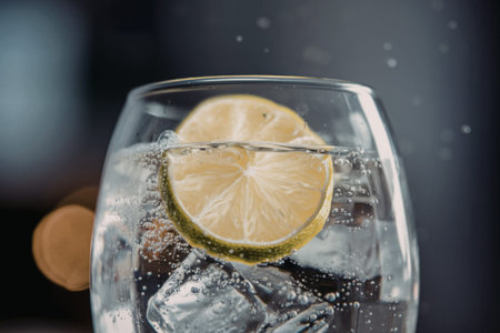 a clear glass filled with a sparkling soda beverageの写真素材