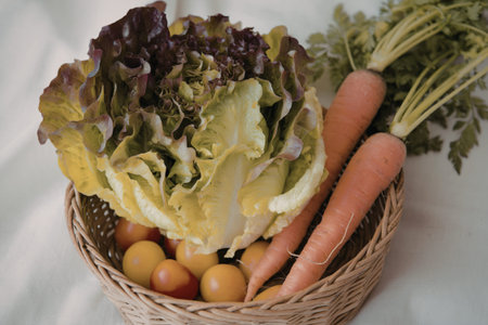 a wicker basket filled with fresh vegetablesの写真素材