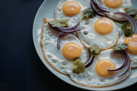 ceramic plate showcasing multiple sunny-side-up eggsの写真素材