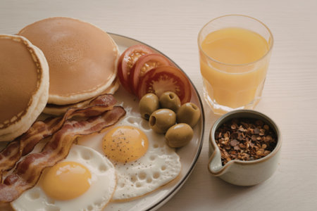 breakfast spread artfully arranged on a light wooden table surfaceの写真素材