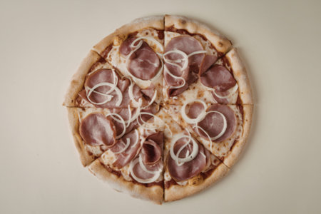 a pizza with ham and onionの写真素材