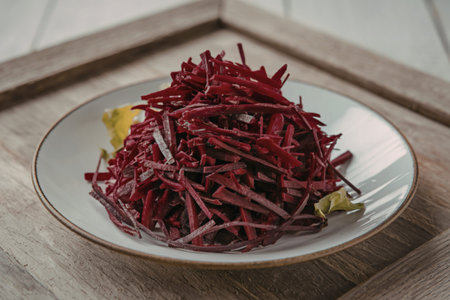 a white plate with a pile of shredded beetroot
