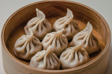 a wooden bowl containing several dumplings