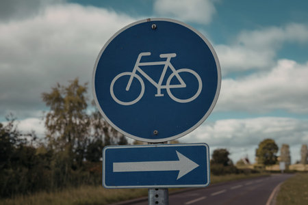 a blue circular sign with a white bicycle icon in the center